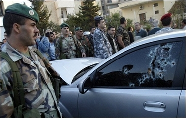 Lebanese security forces surround the bullet-riddled car of assasinated Lebanese Industry Minister Pierre Gemayel