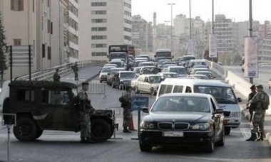 Lebanese soldiers stop cars at a checkpoint on a street in Beirut