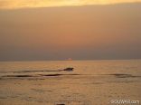 A Boat Crossing The Midline Of Sunset , Jbeil